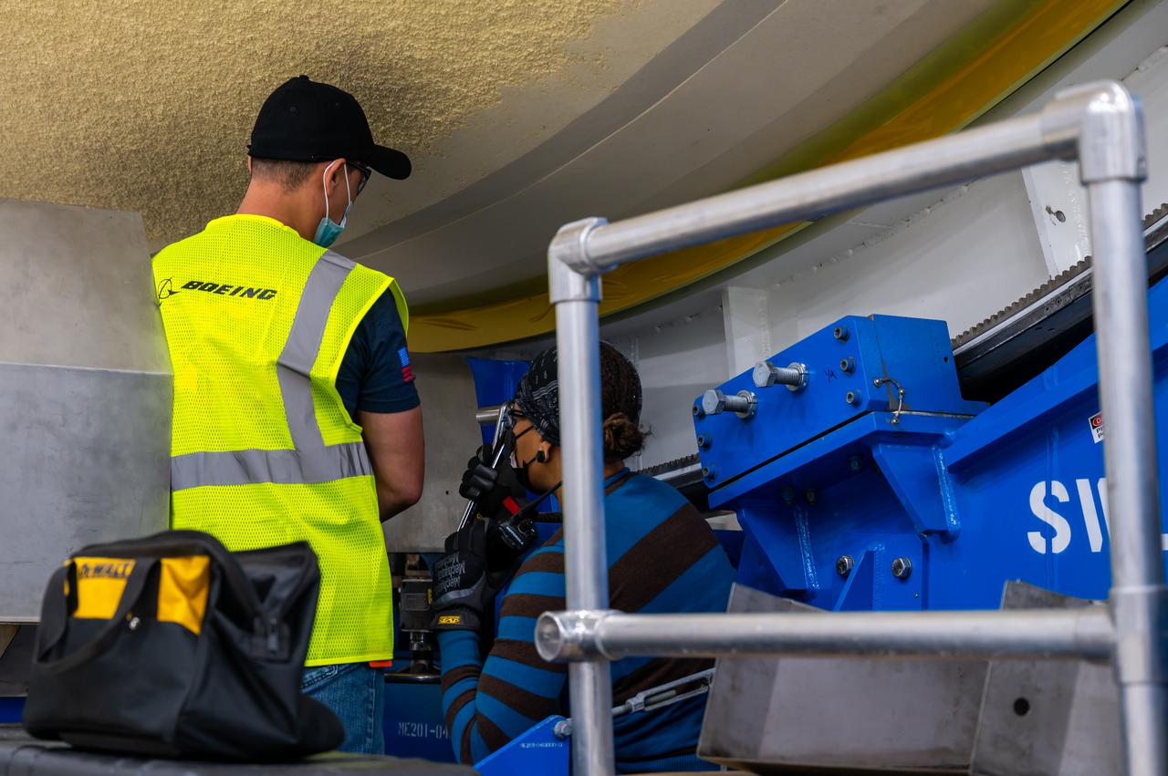 Technicians transported the assembled upper part of the Artemis II core stage to the final assembly area inside the factory at NASA’s Michoud Assembly Facility in New Orleans. On Jan 10, the forward assembly, left was moved next to the Artemis II liquid hydrogen tank, which has been undergoing assembly. Next, Boeing, the lead core stage contractor, will join the forward assembly and the liquid hydrogen tank to complete most of the core stage for the Space Launch System (SLS) rocket that will send the first crew on an Artemis mission. The core stage consists of five major structures that are built, outfitted, and then connected to form the final stage. The forward skirt, liquid oxygen and intertank were connected and tested to form the 66-foot forward assembly. After the forward assembly is joined with the 130-foot liquid hydrogen tank, only the engine section, the fifth piece of the stage, will need to be added to complete the Artemis II core stage. The core stage serves as the backbone of the rocket, supporting the weight of the payload, upper stage, and crew vehicle, as well as the thrust of its four RS-25 engines and two five-segment solid rocket boosters attached to the engine and intertank sections. On Artemis II, the SLS rocket will launch the Orion spacecraft and a crew, sending them into lunar orbit, in preparation for later Artemis missions that will enable the first woman and first person of color to land on the Moon.